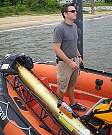 Dr. Adam Skarke standing on boat